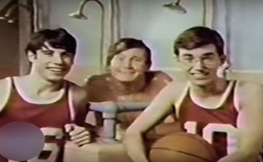 John Travolta and other boys appear as basketball players.