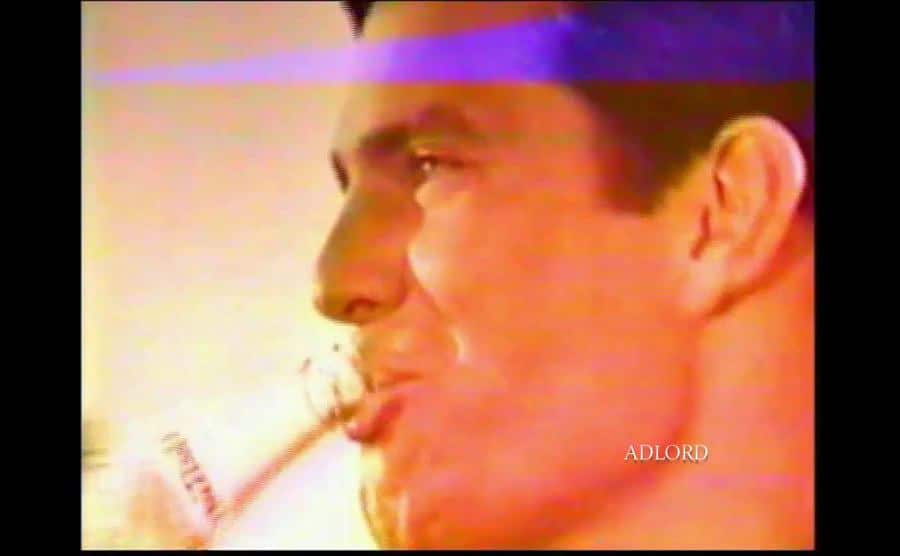 Tom Selleck is drinking out of a Pepsi bottle.