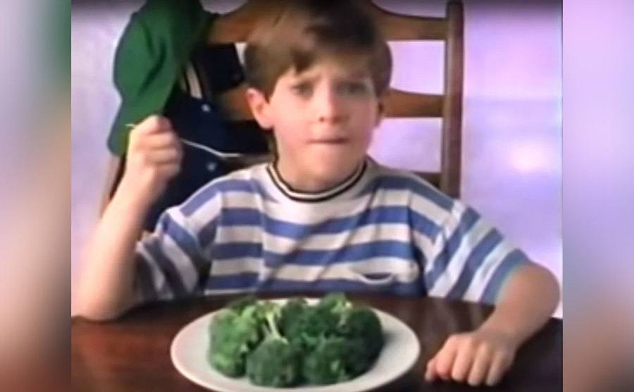 Elijah Wood is eating a plate of broccoli.