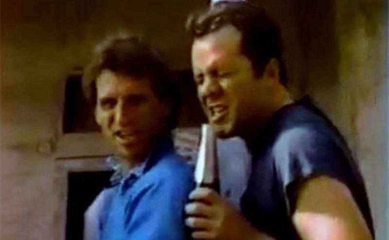 Bruce Willis uses a wine cooler as a microphone.