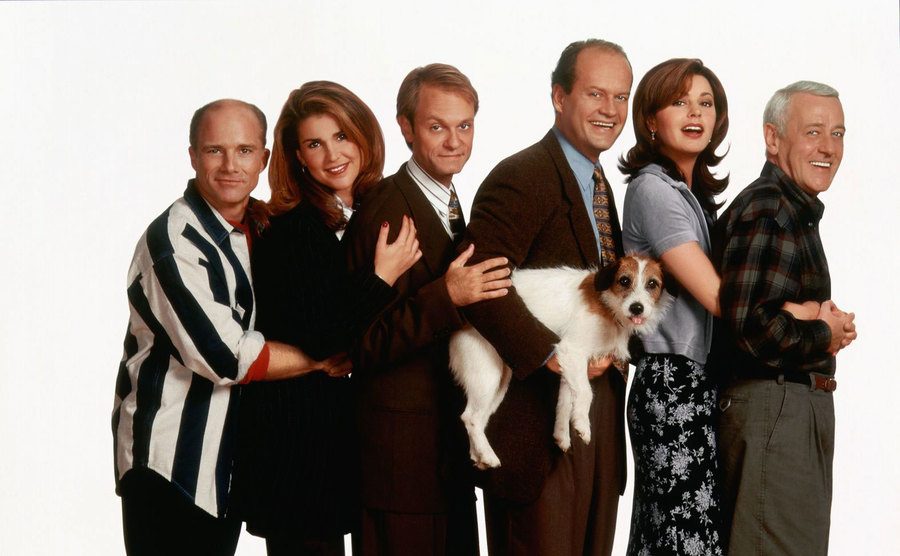 The cast of Frasier poses with the dog.