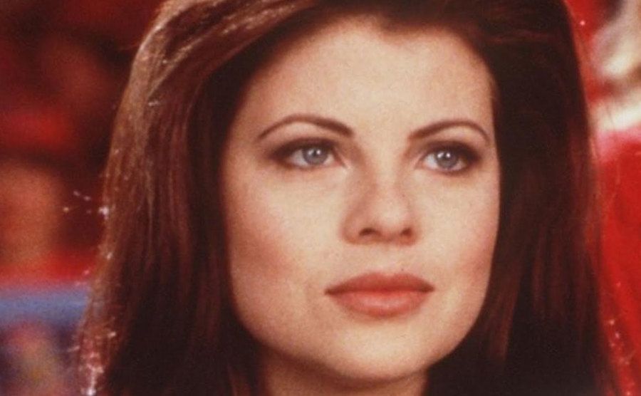A headshot of Yasmine Bleeth during a television show.