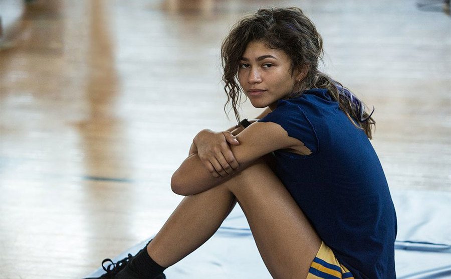 Zendaya, as Michelle 'MJ' Jones¸sits on the gym floor.