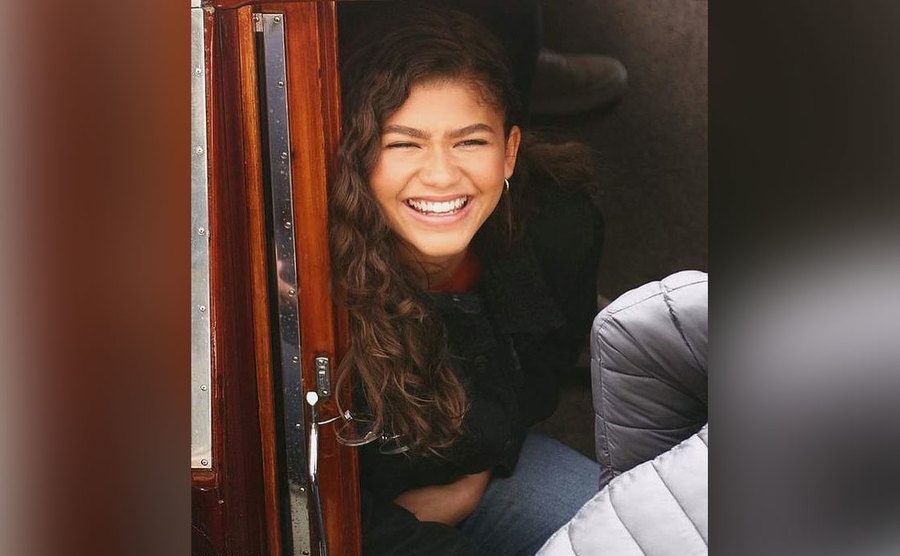 A photo of a laughing Zendaya.