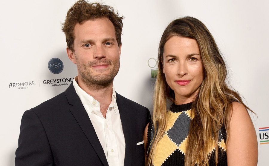 Jamie Dornan and Amelia Warner attend an event.