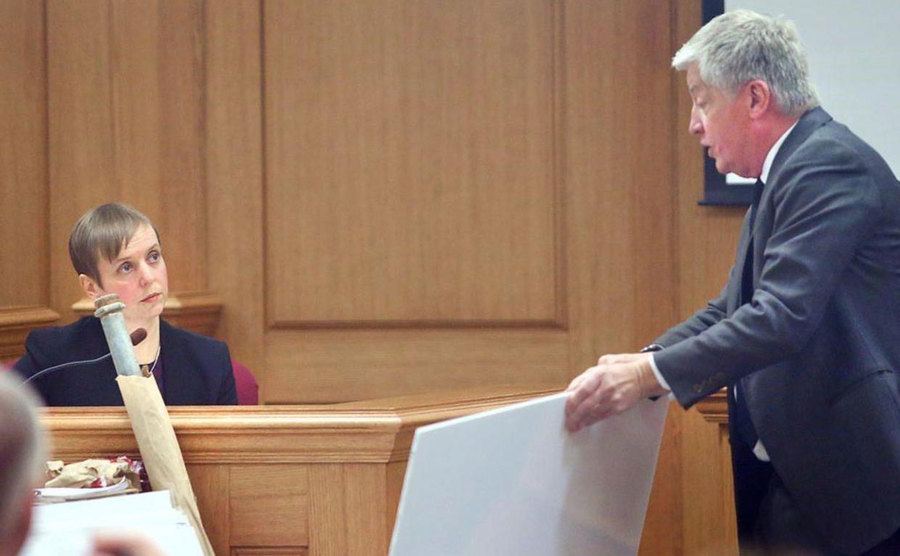 A photo of the medical examiner testifying in court.