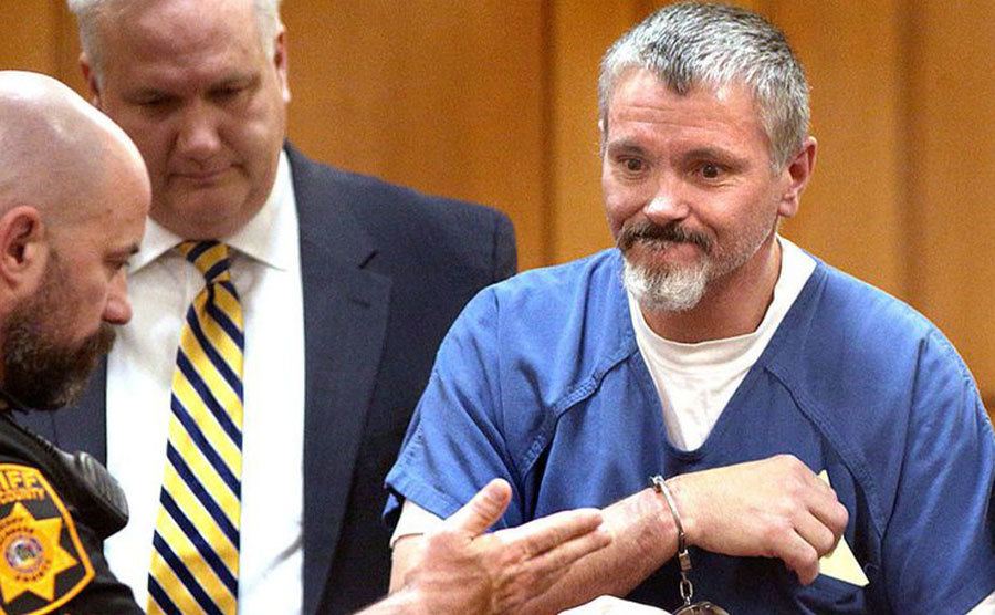 An image of Todd handcuffed during the trial.