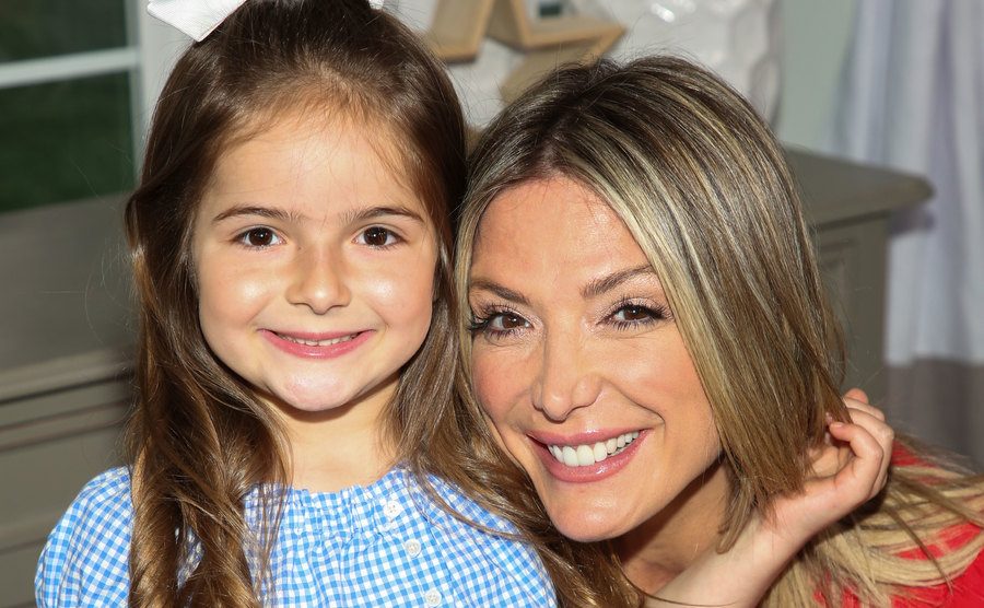 Debbie poses for a portrait with her daughter.