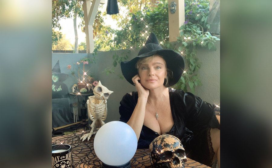Erika is dressed as a witch for her podcast.