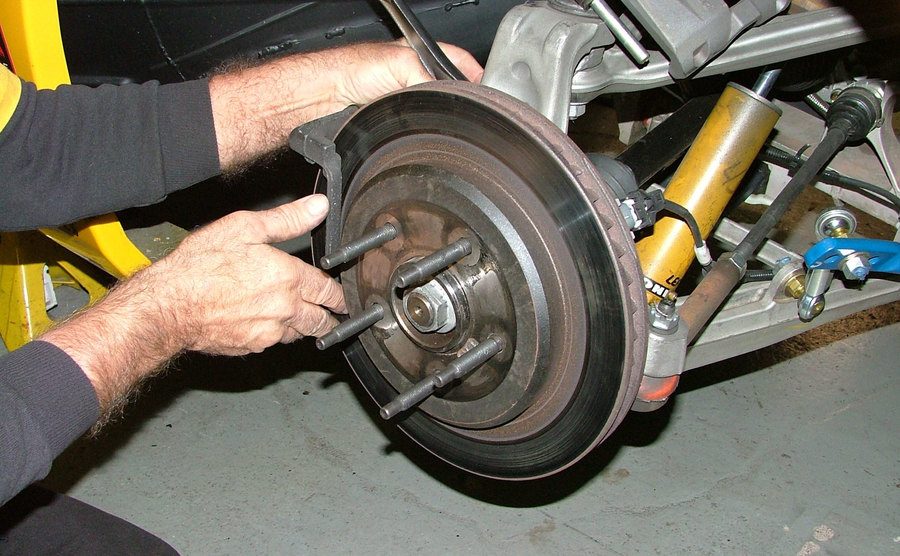 An image of a mechanic fixing a car.