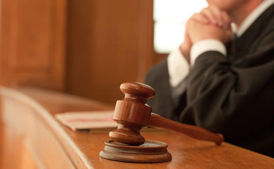An image of a judge and a gavel in a courtroom.