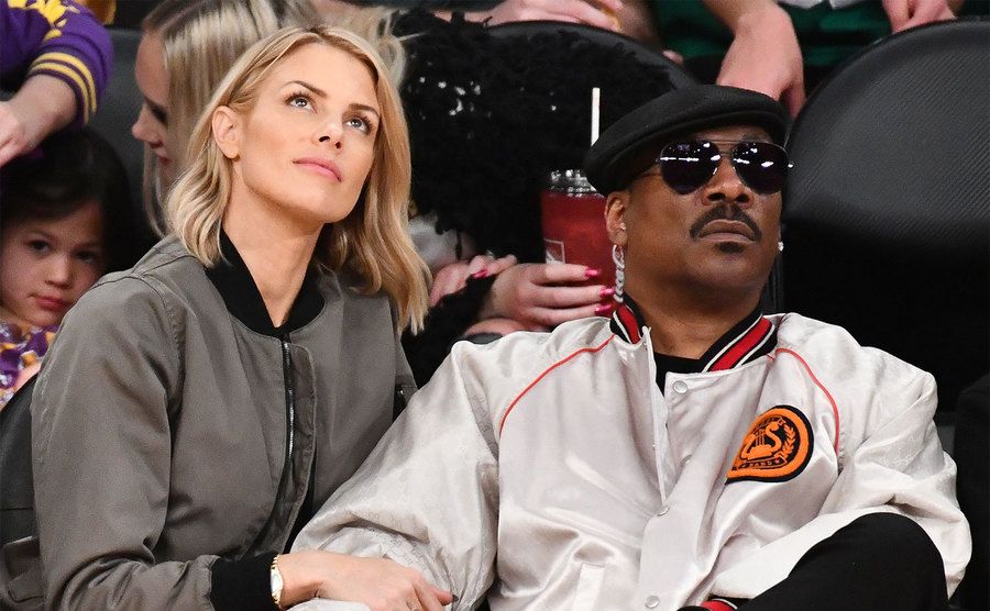 Paige Butcher and Eddie Murphy attend a basketball game. 