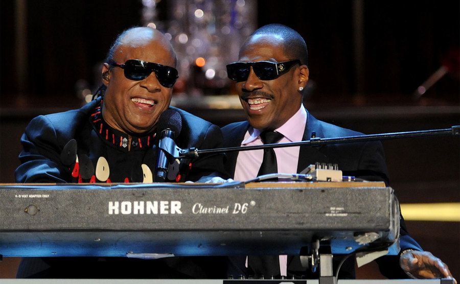 Stevie Wonder and Eddie Murphy perform onstage. 