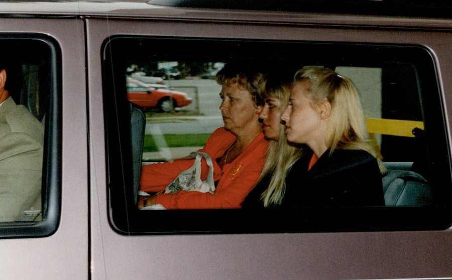 An image of Karla Homolka with her family sitting in the backseat of a van.