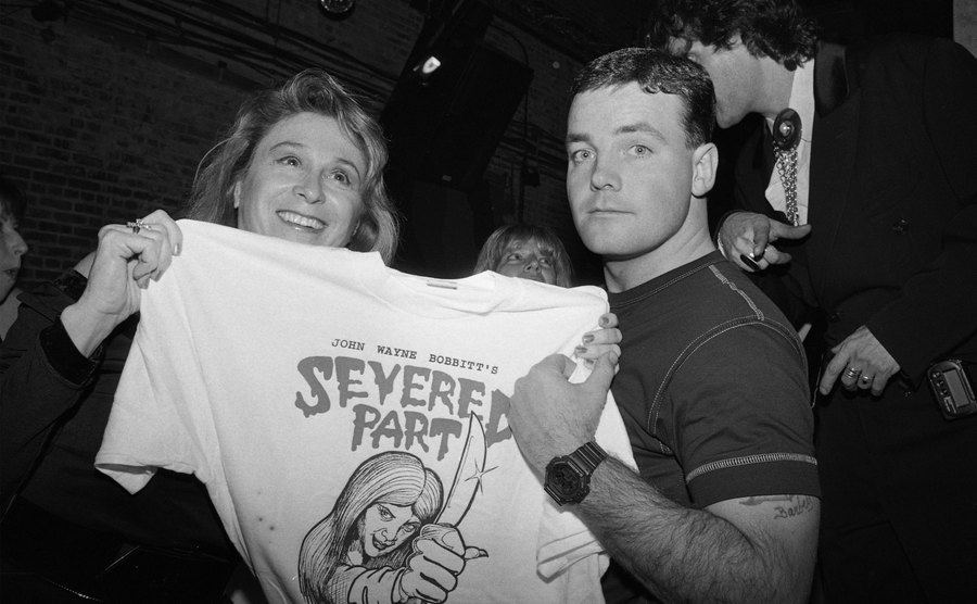 John poses for a photo holding a t-shirt that reads Severed Part.