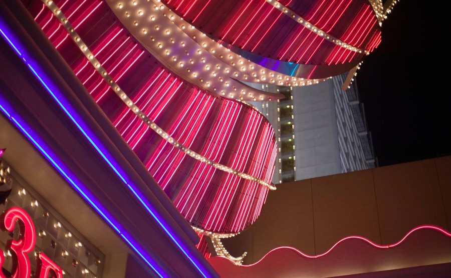 An image of neon lights on top of a casino.