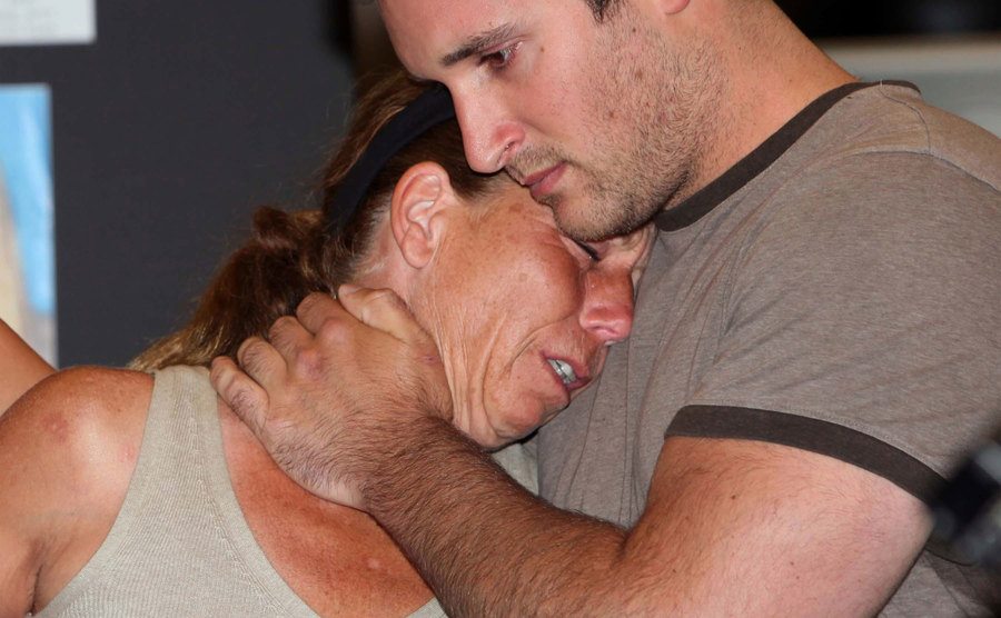 Fiore’s mother cries while being comforted by a friend.