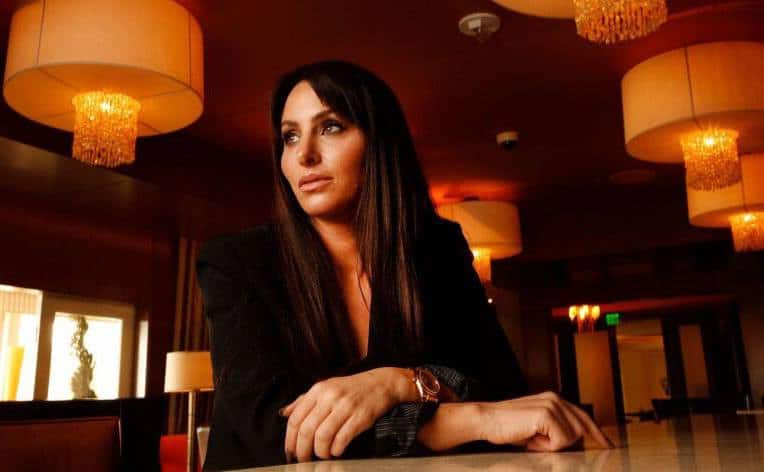 Molly Bloom poses for a portrait in a restaurant.