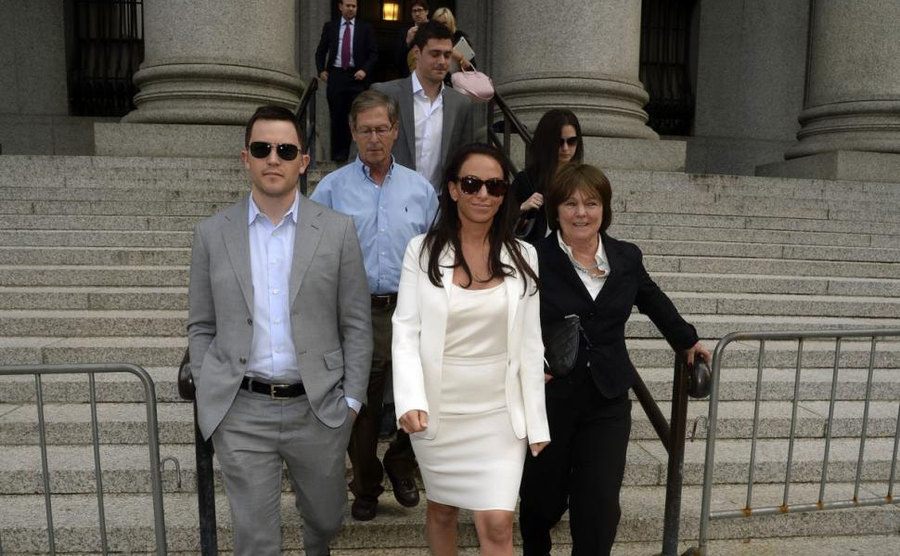 Molly Bloom walks out of court with her lawyers.