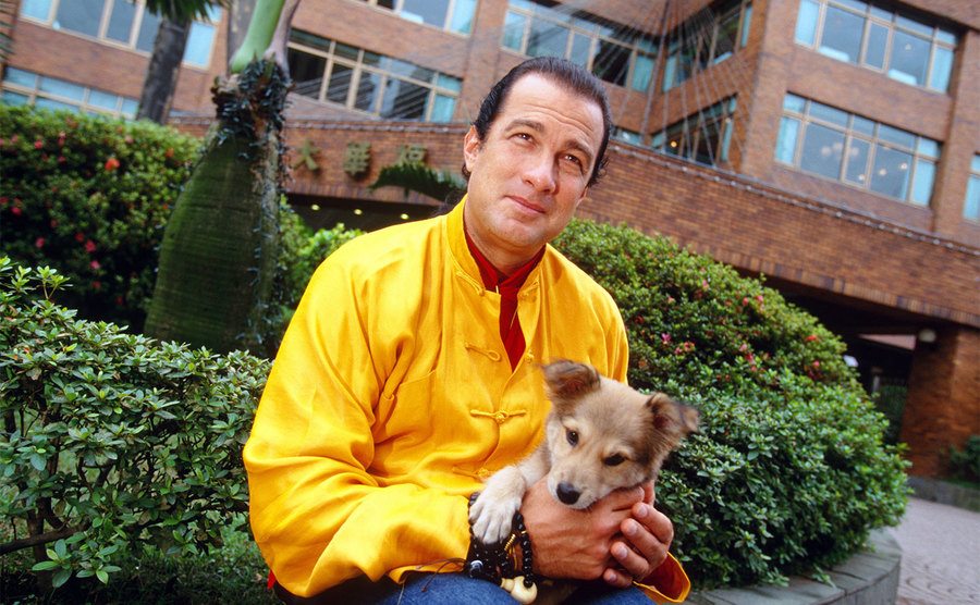 Steven Seagal poses with a puppy.