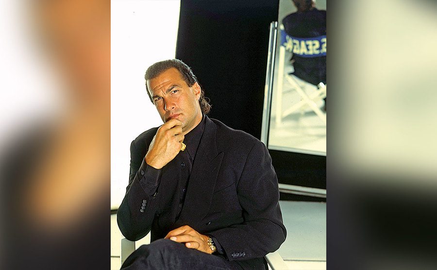 Steven Seagal is posing on set.