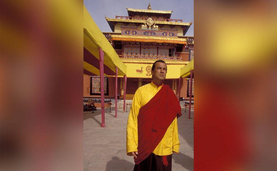 Steven Seagal walks the ground of a Buddhist temple.