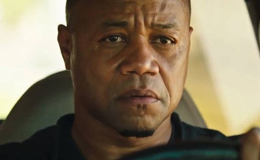 A still of Gooding Jr. driving a car in a scene from the film.