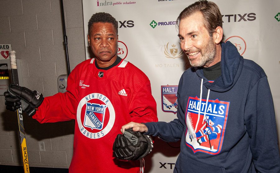 Gooding Jr. and Former NHL Player Chris Tschupp pose for the press.