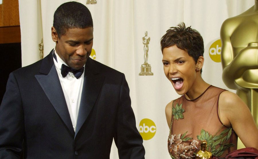 Washington and Halle Berry pose backstage at the Oscars.