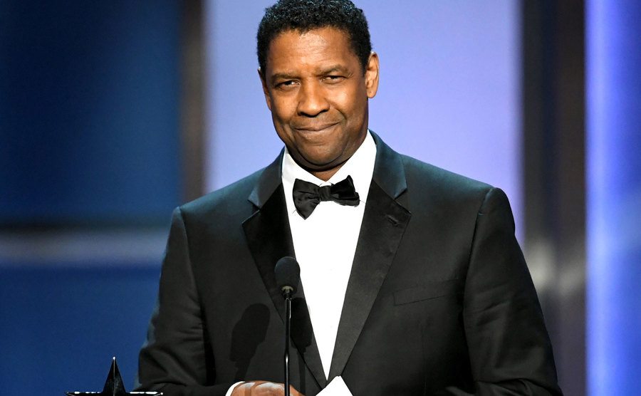 Washington speaks on stage.
