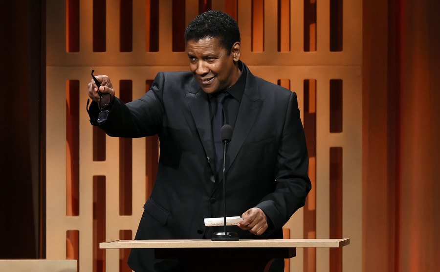 Washington speaks on stage.