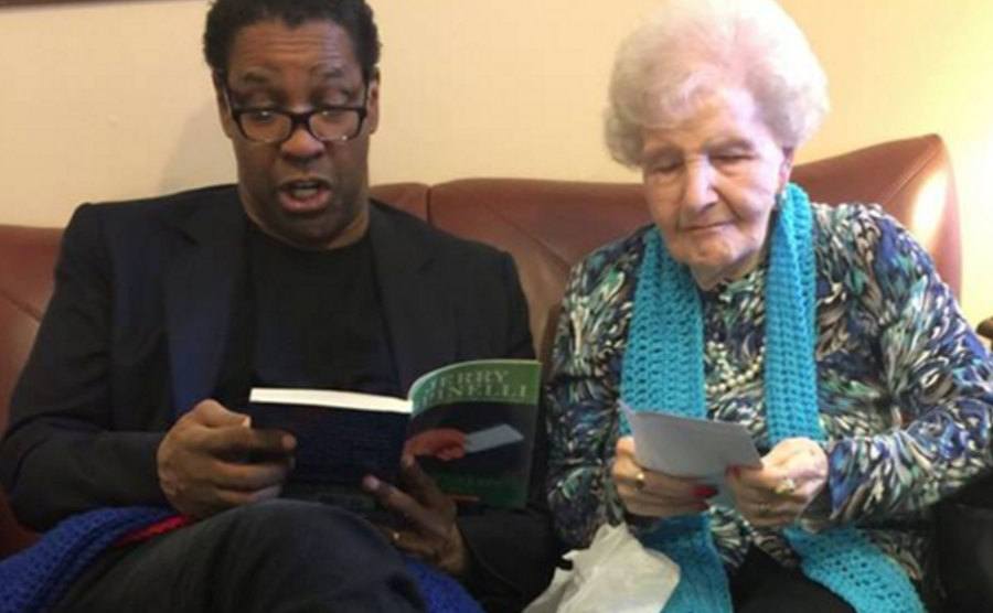 A picture of Washington sits next to Miss Connie as they read a book.