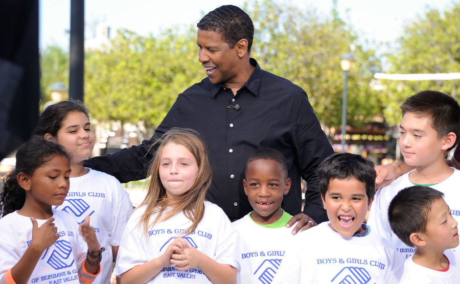 Washington poses with children from the Boys and Girls Club.