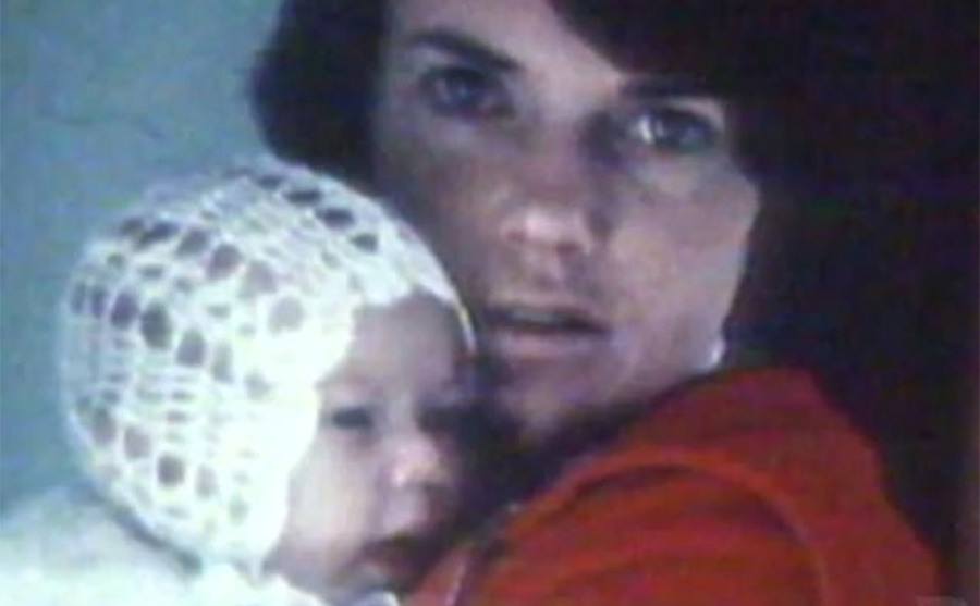 A portrait of Lindy holding baby Azaria.