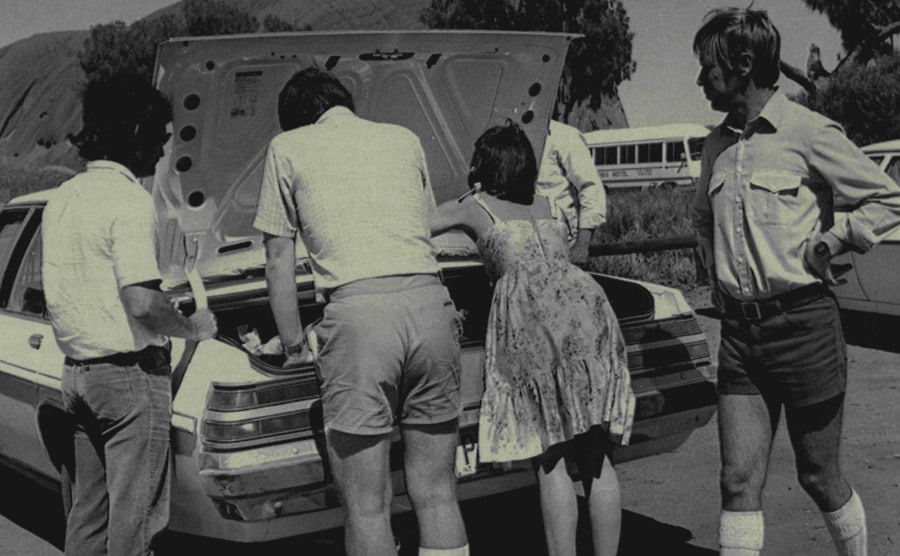 An image of Michael and Lindy standing next to their car.