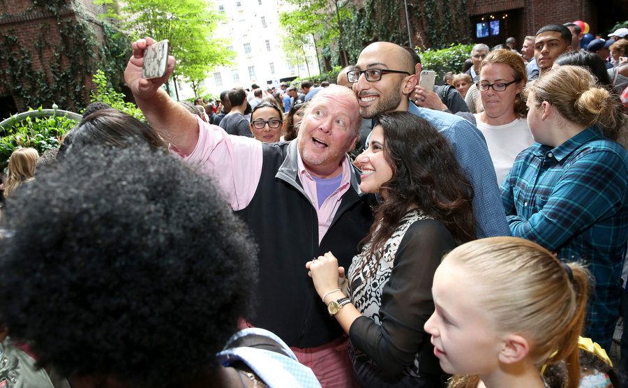 Batali takes photos with his fans.