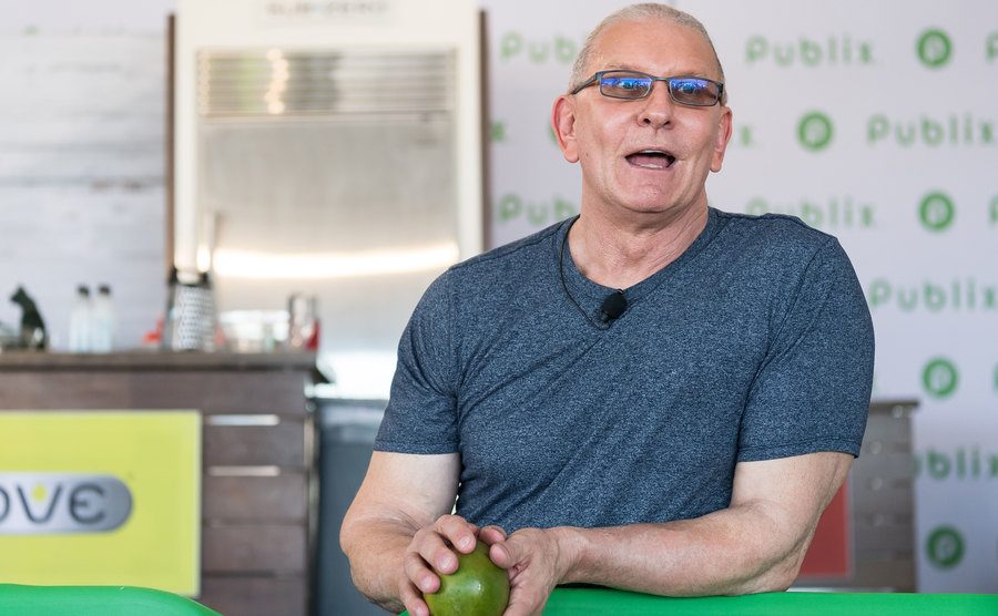 Robert Irvine performs a cooking demo on stage.