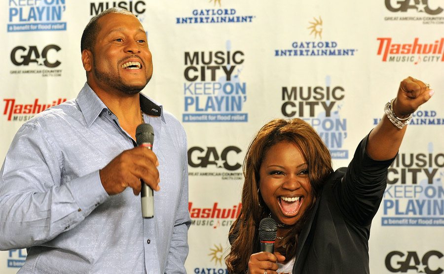 A photo of Patrick and Gina Neely talking to the press.