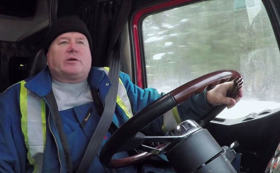 Jamie Davis speaks as he rides a truck.