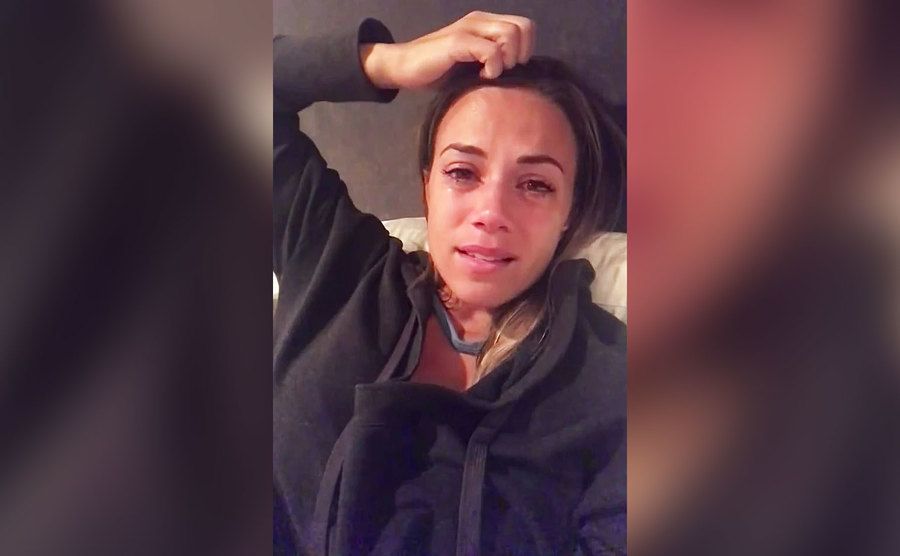A selfie of Jana crying in bed.
