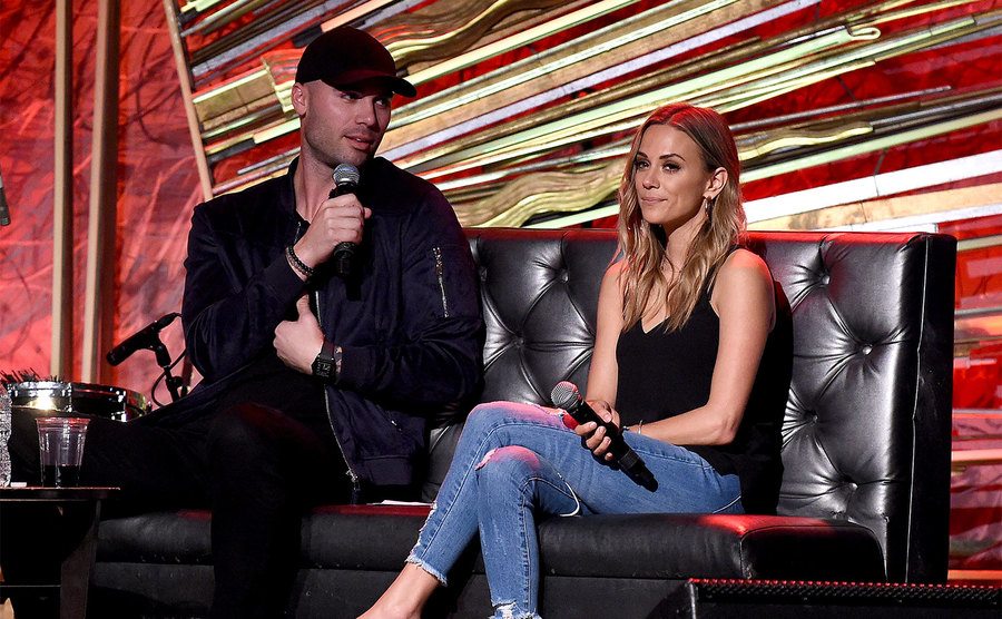 Mike Caussin and Jana Kramer speak onstage.
