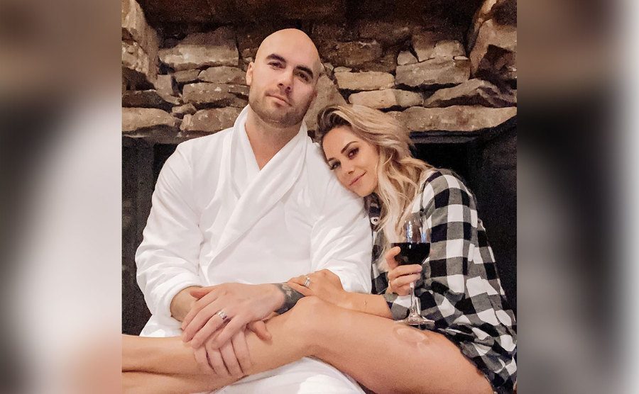 Mike and Jana cuddle together at home.