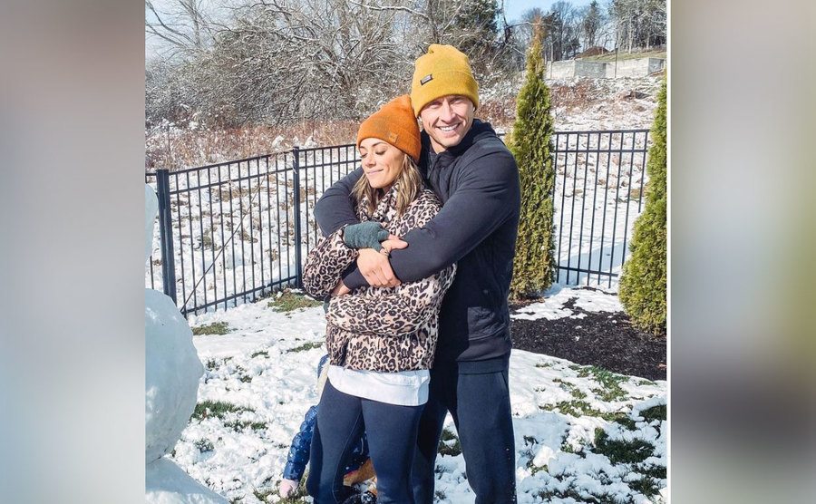 Jana and Ian make a snowman in the backyard.
