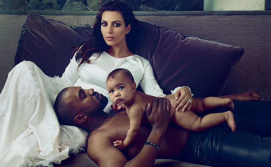 Kim, Kanye, and baby North pose at home.