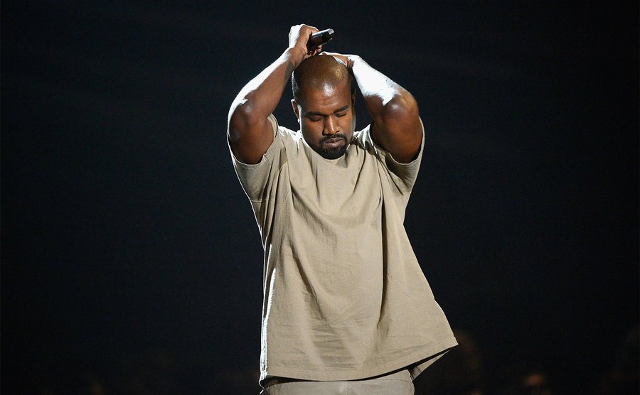 Kanye West performs on stage.