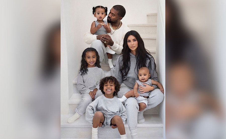 Kim and Kanye pose with their kids at home.