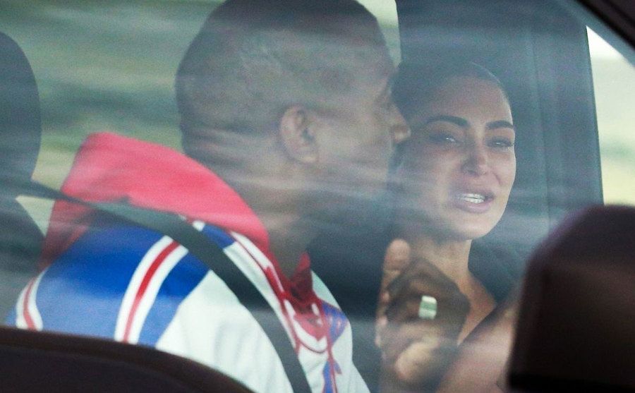 Kim and Kanye have a tearful argument in a car.
