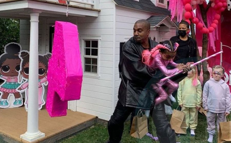 Kanye helps Chicago with the pinata on her birthday.
