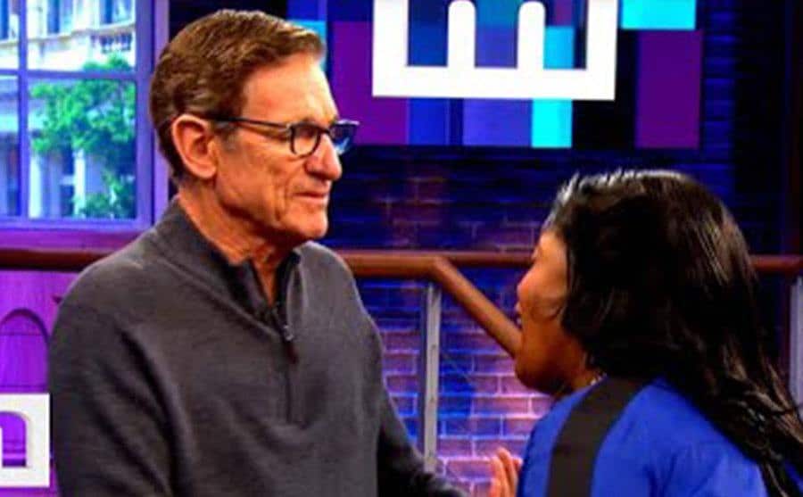 A still of Maury and a contestant in a still from the show.