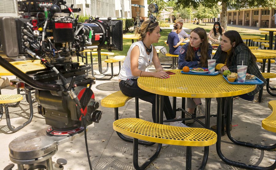 Wilde talks to her actresses on the set of Booksmart.